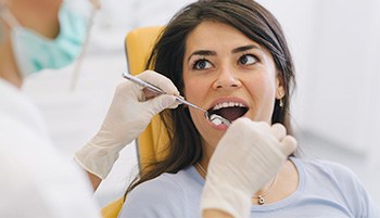 Woman receiving tooth removal treatment