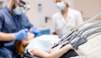 dental procedure with instruments in foreground