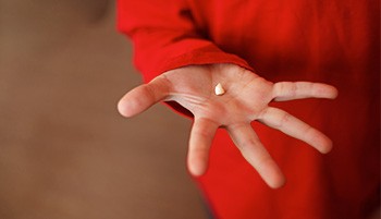 Hand holding an extracted tooth