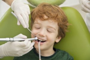 boy smiling getting dental cleaning