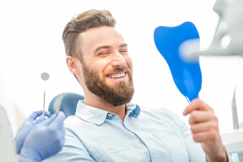 man smiling looking in mirror 